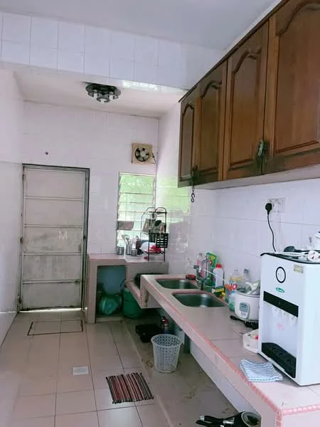 Kitchen features: white tiled walls, brown wooden upper cabinets, double-bowl stainless-steel sink, chrome pull-down faucet, countertop with pink edge, ceramic tile flooring, window above sink, door leading outside, kitchen appliances including a water dispenser, various kitchen utensils and containers.