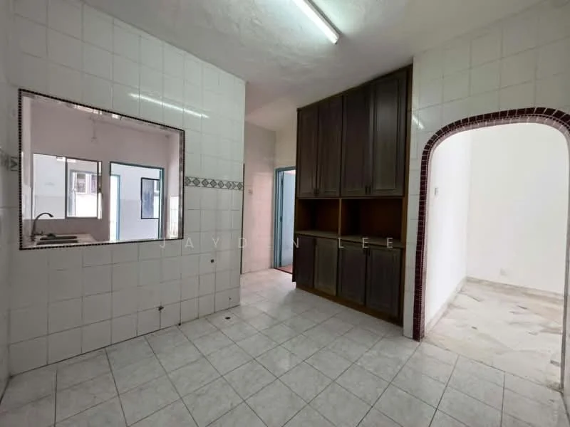 Kitchen features: white tiled walls, grey tiled flooring, wood cabinetry, arched doorway, open layout, counter space, sink area, wall-mounted light fixture.