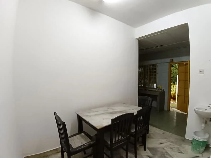 Dining features: white painted walls, marble dining table, 4 black wooden dining chairs, green tiled flooring, doorway leading to kitchen, sink with faucet, natural light from doorway.