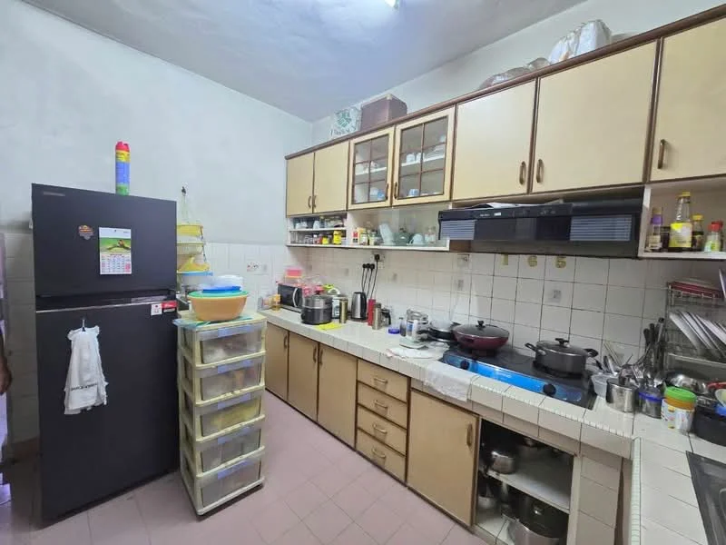 Kitchen features: black fridge, wood cabinetry with cream finish, glass-front upper cabinets, white tiled backsplash, stainless-steel sink, double-burner gas stove, countertop with tiled surface, various kitchen appliances, plastic storage containers, wall-mounted shelves, pink tiled flooring; style: traditional.