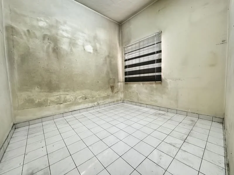 Room features: white painted walls with stains, black and white striped window blinds, white tiled flooring, no visible furniture, corner room, natural light from window.