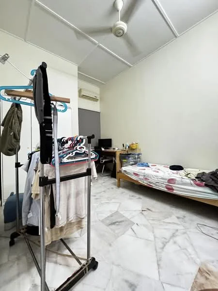 Bedroom features: single bed with bedding, clothes rack with hangers, marble flooring, white painted walls, ceiling fan, study desk, chair, window with curtain, light source from ceiling.