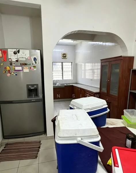 Kitchen features: stainless-steel fridge, white cabinets, countertop, tile backsplash, window above sink, built-in wooden cabinet, ceramic tile flooring, archway entrance. Room features: coolers, table with cloth, decorative magnets on fridge.
