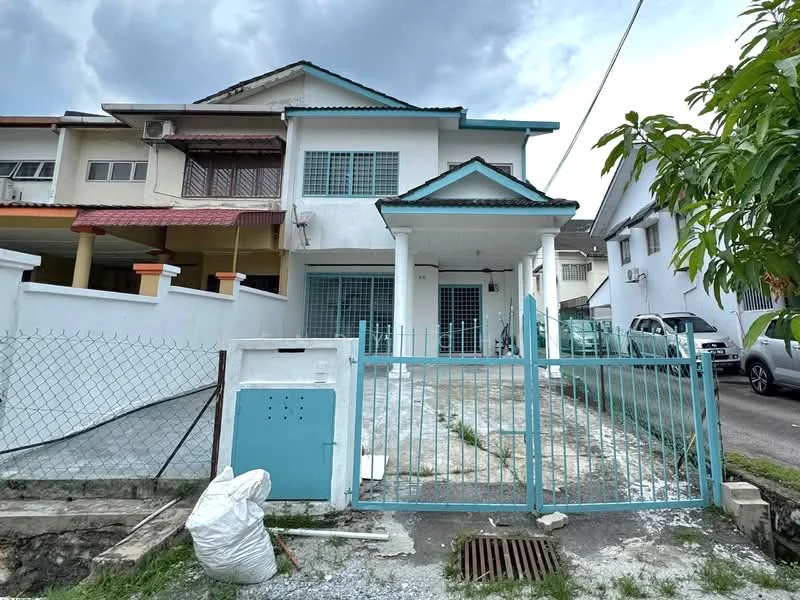 Exterior type: semi-detached house; features: white painted facade, blue accents on roof and gate, front yard with gravel, metal gate, concrete driveway, fenced perimeter, two-storey structure, gabled roof, windows with grilles, adjacent parking area; style: modern.
