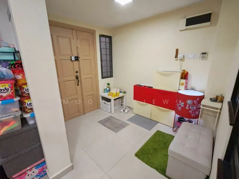 Room features: cream painted walls, tile flooring, recessed ceiling lights, wall-mounted air conditioning unit, double-door entrance, grey storage ottoman, red storage cabinet, white shelving unit, green area rug, various storage boxes, window with grid pattern, doorbell, power outlets; style: modern.
