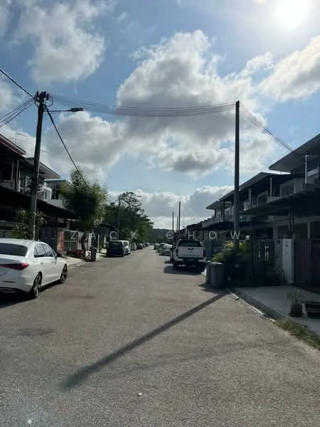 Exterior type: linked terrace house; features: residential street view, two-storey linked terrace houses, paved road, street lighting, utility poles, parked cars, greenery along the street, cloudy sky; style: modern.