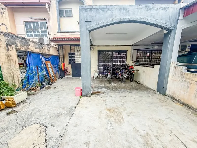 Exterior type: linked terrace house; features: concrete driveway, covered car porch, exposed brick walls, windows with metal grilles, outdoor storage area, manicured garden area, motorcycles parked, plastic chair, blue tarpaulin, concrete flooring; style: traditional.