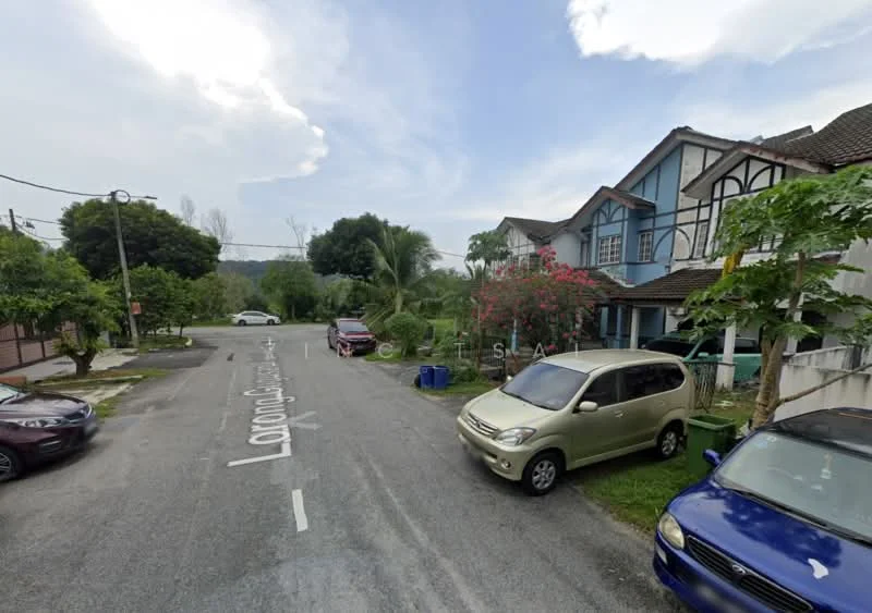 Exterior type: linked terrace house; features: two-storey building, blue painted facade, timber accents, manicured lawn, mature trees, paved driveway, street view, surrounded by greenery; style: traditional.