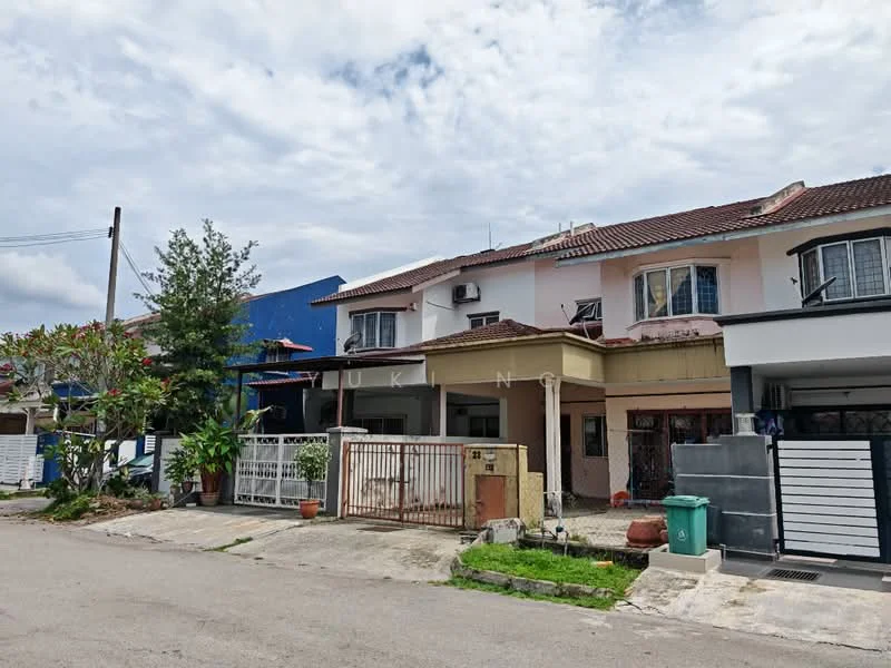 Exterior type: linked terrace house; features: two-storey structure, white painted facade, red tiled roof, front porch with gate, manicured lawn, potted plants, air conditioning units visible, driveway with interlocking pavers, surrounded by greenery, street view, adjacent houses visible; style: modern.