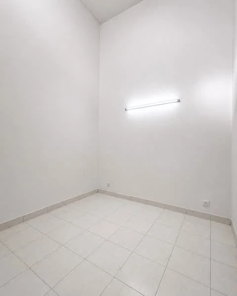 Room features: white painted walls, tile flooring, fluorescent light fixture, high ceiling.