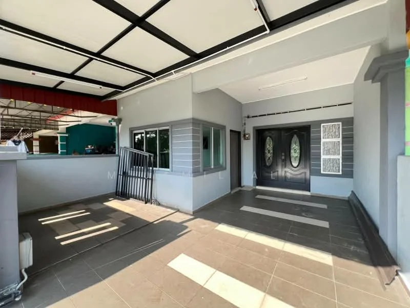 Exterior type: detached bungalow; features: grey painted facade, double front doors with decorative panels, tiled flooring, covered porch area, sliding glass door, windows with grey frames, exposed ceiling beams, manicured landscaping visible in background; style: modern.