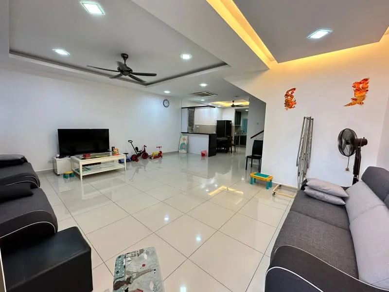 Living features: white painted walls, polished ceramic tile flooring, tray ceiling with recessed lighting, 5-blade ceiling fan, wall-mounted TV, black fabric 3-seater sofa, grey fabric 2-seater sofa, coffee table, decorative wall art, open layout to kitchen, clock on wall, children's toys visible; style: modern. Kitchen features: open layout to living room, kitchen island, stainless-steel appliances, grey cabinetry, tile backsplash; style: modern.