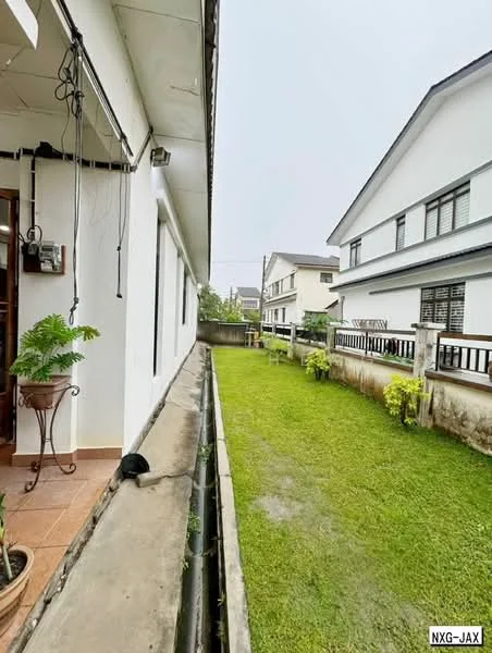 Exterior type: linked terrace house; features: white painted facade, manicured lawn, paved walkway, planters with greenery, two-storey building, gated entry, surrounded by residential buildings; style: modern.