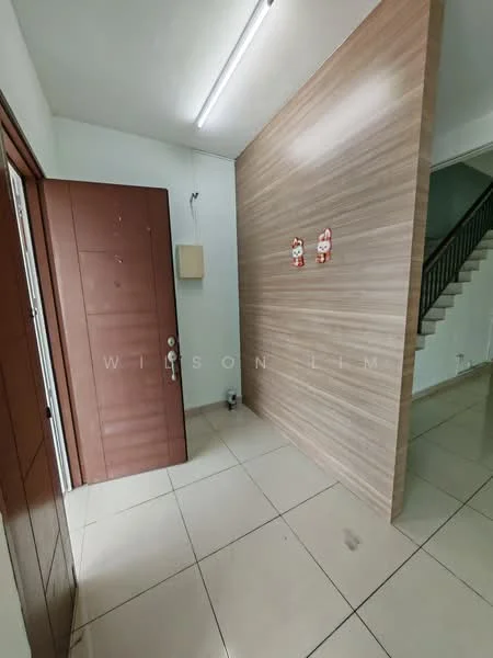 Room features: brown wooden door, cream tiled flooring, light brown wood panel accent wall, white walls, ceiling light fixture, staircase visible in background, decorative wall art, intercom system; style: modern.