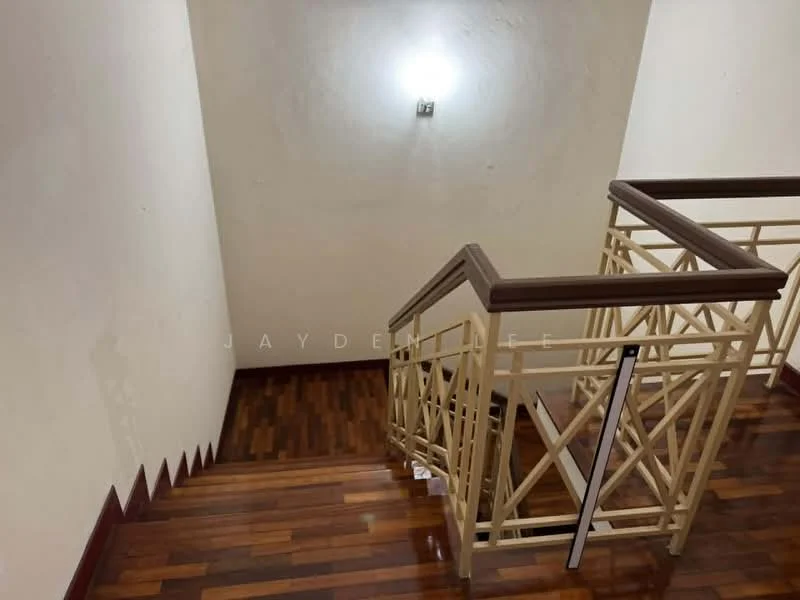 Room features: wooden staircase, metal railing, white painted walls, wall-mounted light fixture, dark wood flooring.