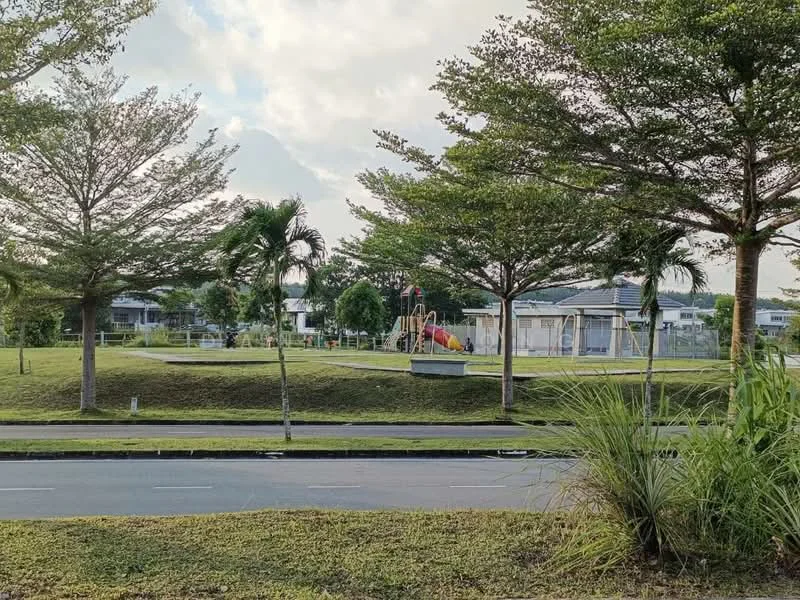 Exterior type: landscape garden; features: manicured lawn, mature trees, playground equipment, paved walkway, surrounding greenery, open grassy area, street view, sidewalk, residential buildings in background; style: modern.