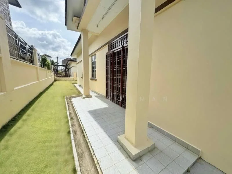 Exterior type: detached bungalow; features: cream painted facade, flat roof, single-storey, manicured lawn, paved walkway, side garden, windows with metal grilles, patio area, fenced perimeter; style: modern.