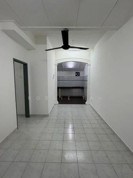 Room features: white painted walls, grey tiled flooring, 5-blade ceiling fan, arched doorway, recessed ceiling, kitchen area visible in background.