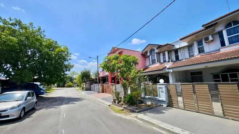 Exterior type: linked terrace house; features: two-storey linked terrace, red painted facade, cream painted facade, tiled roof, manicured front garden, paved walkway, fenced front yard, driveway with interlocking pavers, street view with mature trees, clear blue sky; style: modern.