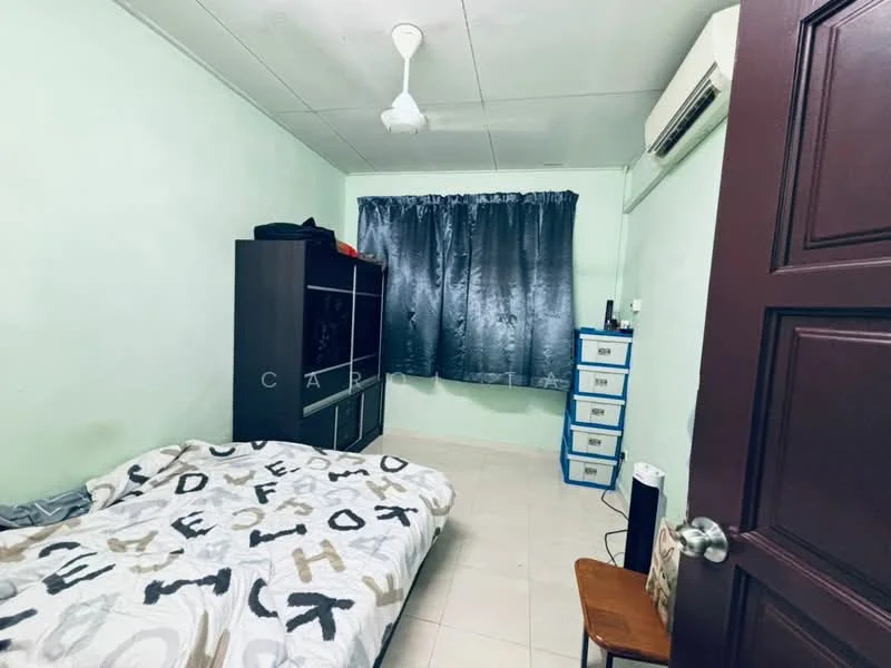 Bedroom features: green painted walls, tile flooring, ceiling fan, window with grey curtains, double bed with patterned bedding, black storage unit, white dresser with multiple drawers, wooden chair, air conditioning unit.