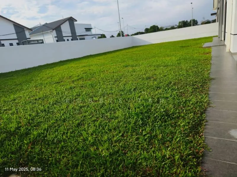 Exterior features: manicured lawn, green grass, white boundary wall, paved walkway, surrounding residential buildings, open space.