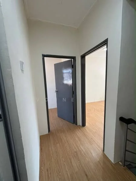 Room features: light wood laminate flooring, white painted walls, grey door frames, two doorways leading to adjacent rooms, no visible windows, simple ceiling, neutral decor; style: minimalist.