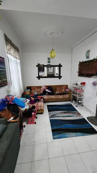 Living features: white painted walls, high ceiling with ceiling rose, recessed downlights, large window with sheer curtains, striped fabric sofa, decorative mirror, area rug with abstract pattern, coffee table, standing fan, various bags and items scattered; style: modern.