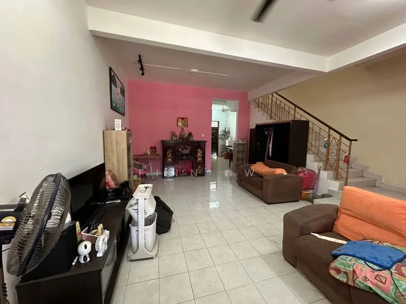 Living features: white tiled flooring, pink accent wall, cream painted walls, 2-seater brown fabric sofa, 3-seater orange fabric sofa, TV console, wall-mounted TV, ceiling fan, decorative items on shelves, staircase leading to upper floor, open layout to kitchen area; style: modern. Room features: kitchen area visible in background, wooden cabinetry, appliances not specified.