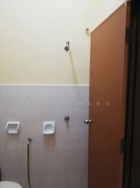 Bathroom features: yellow painted walls, light grey tiled walls, shower head, toilet, toilet paper holder, wall-mounted soap dish, door, floor tiles.