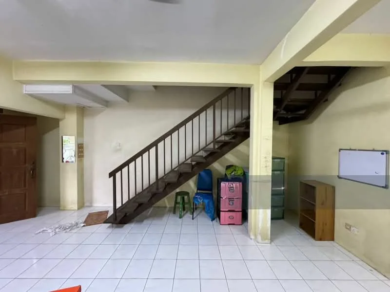 Room features: white painted walls, white tiled flooring, wooden staircase, wooden handrail, green plastic stool, pink storage cabinet, metal filing cabinet, wooden bookshelf, ceiling fan; style: minimalist.