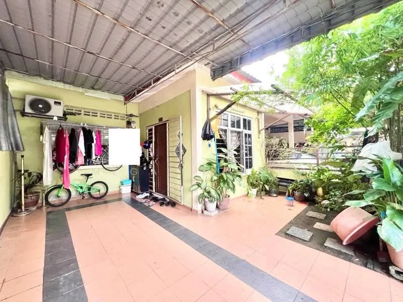 Room features: tiled flooring in light pink, green painted walls, exposed ceiling with metal roofing, wall-mounted split AC unit, large window with white frame, potted plants, clothes hanging on a rack, bicycle, outdoor space with plants, stone-paved walkway; view: garden.