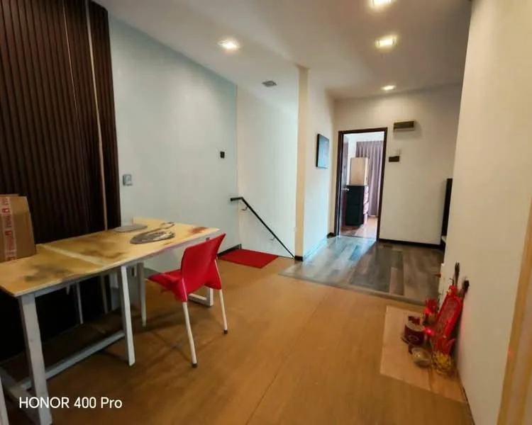 Room features: light wood flooring, white painted walls, dark wood accent wall, recessed downlights, staircase leading to upper level, small wall-mounted TV, dining table with four red chairs, decorative altar with offerings, air conditioning unit, doorway leading to another room; style: modern.