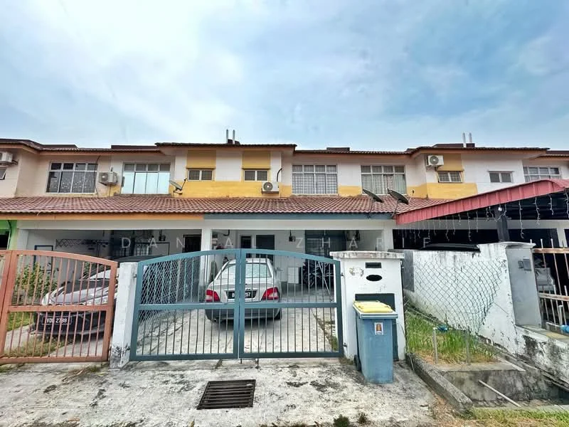 Exterior type: linked terrace house; features: two-storey building, yellow and white painted facade, red tiled roof, front gate with metal bars, driveway with parking space, visible air conditioning units, fenced perimeter, manicured lawn, concrete walkway; style: modern.