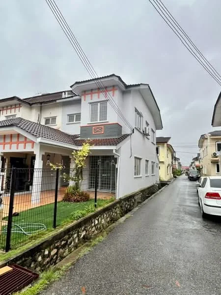 Exterior type: semi-detached house; features: white painted facade, grey tiled roof, stone-clad boundary wall, manicured lawn, paved walkway, front porch, window grilles, decorative wooden elements, fenced front yard, two-storey structure; style: modern.