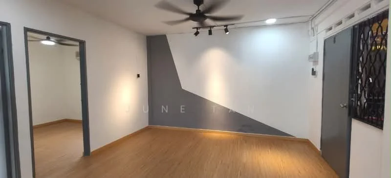 Room features: white painted walls, grey accent wall, wooden flooring, 5-blade ceiling fan, recessed LED downlights, track lighting, security grille door, open space layout; style: modern.