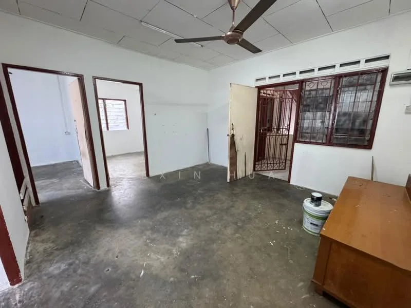 Room features: white painted walls, concrete flooring, ceiling fan, window with metal grille, wooden door, wooden furniture, multiple doorways, natural light from windows; style: minimalist.