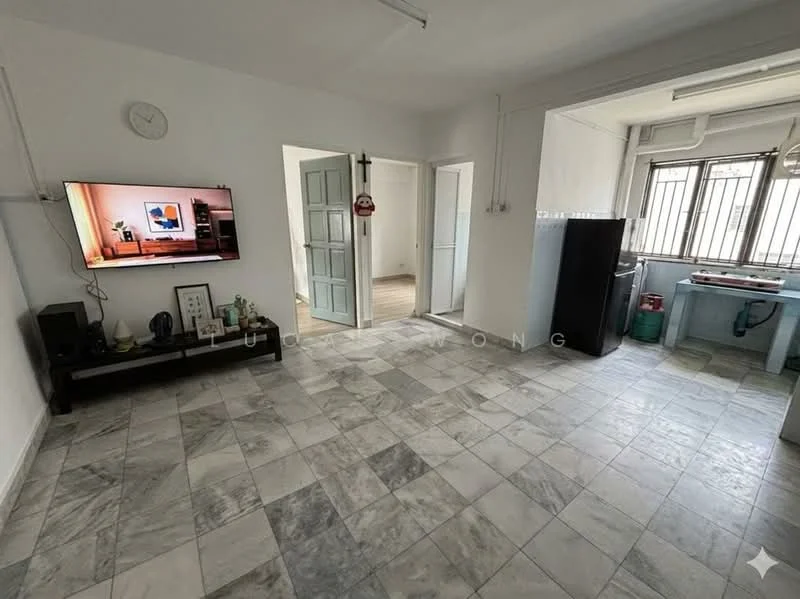 Living features: marble tile flooring, white painted walls, wall-mounted TV, black TV console, ceiling lights, large windows with metal grilles, open layout to kitchen, clock on wall; style: modern. Kitchen features: ceramic tile flooring, blue cabinetry, stainless-steel fridge, kitchen countertop, sink, gas stove, wall-mounted cabinets; style: modern.