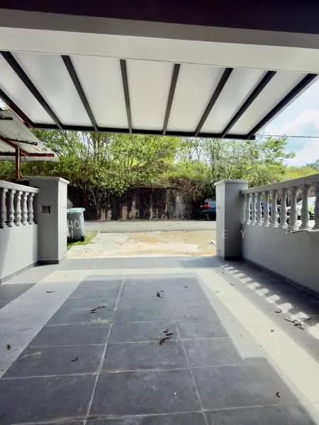 Exterior type: car porch; features: flat roof with retractable awning, grey painted walls, stone-paved flooring, decorative balustrade, manicured landscaping, visible driveway, surrounded by greenery; style: modern.