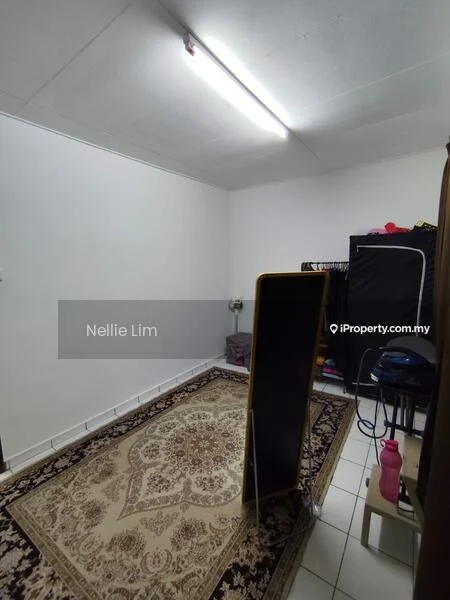 Room features: white painted walls, tile flooring, area rug with intricate pattern, full-length mirror, clothing rack, plastic water bottle, folding chair, light fixture on ceiling.