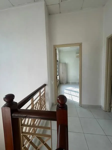 Room features: white painted walls, tile flooring, wooden railing, doorway leading to another room, window with sheer curtains, natural light from window, ceiling with visible tiles.