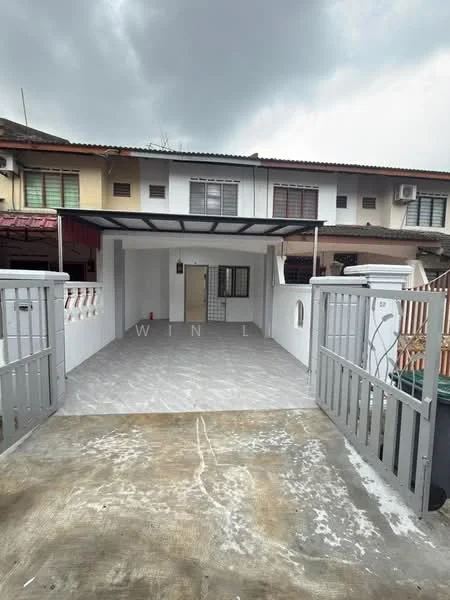 Exterior type: linked terrace house; features: grey painted facade, flat roof, open-air parking area, front gate, paved driveway, white railing, mature trees in background, multiple air conditioning units visible, front porch area, surrounded by residential buildings; style: modern.
