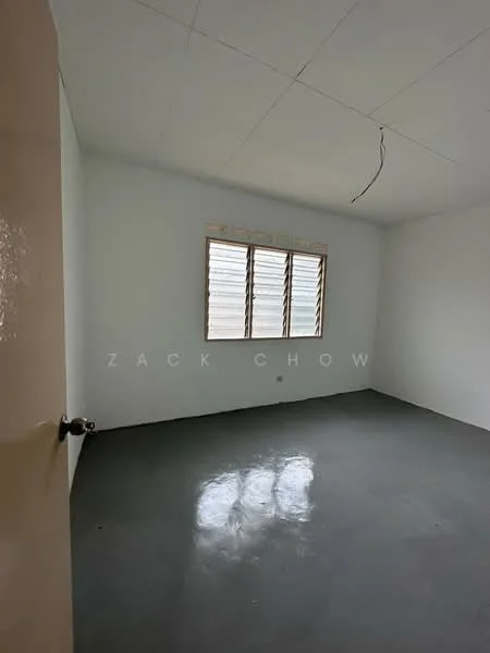 Room features: white painted walls, concrete flooring, sliding windows with horizontal slats, single door, ceiling with no visible fixtures.