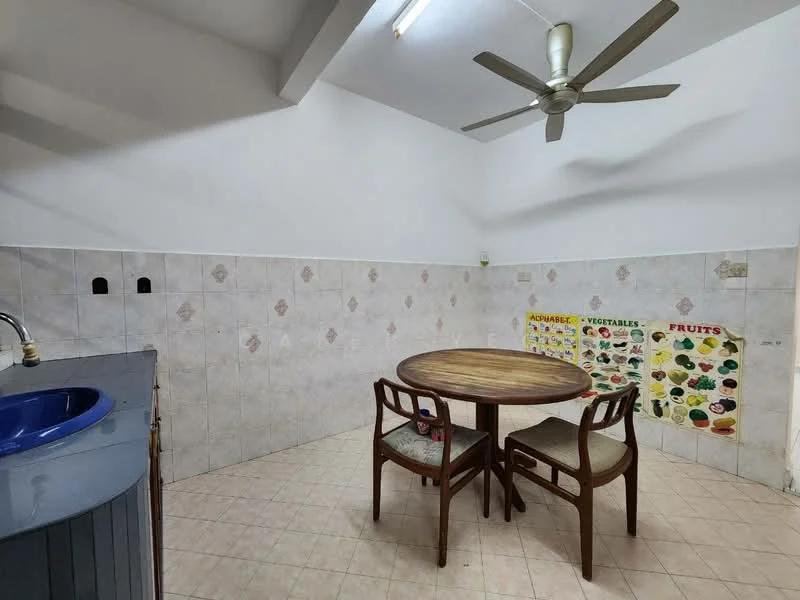 Dining features: round wooden dining table, 2 wooden chairs with cushions, blue sink with faucet, white tiled walls, light-colored tiled flooring, ceiling fan with 5 blades, wall-mounted posters of fruits and vegetables, recessed ceiling lights.