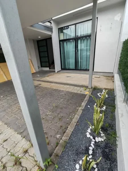Exterior features: paved walkway, landscaped garden with white stones, green plants, glass sliding door, concrete columns, exterior wall with light-colored finish; style: modern.