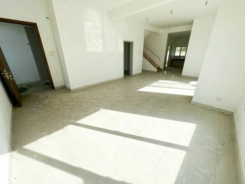 Living features: white painted walls, light-colored tile flooring, large windows allowing natural light, high ceiling, staircase visible in background, doorway leading to another room, open layout, no visible furniture; style: modern.