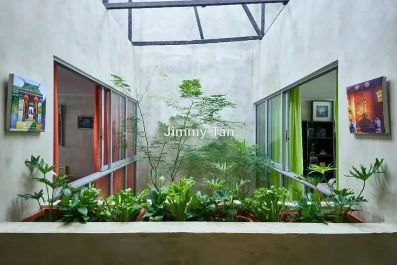 Room features: concrete walls, glass sliding doors, green plants in pots, decorative artwork on walls, natural light from skylight, exposed beams, indoor garden, neutral color palette; style: modern; view: garden.