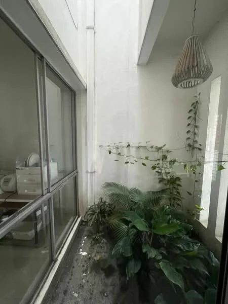 Room features: glass sliding door, white painted walls, hanging pendant light, indoor plants, concrete flooring, greenery, natural light from windows; style: modern; view: garden.
