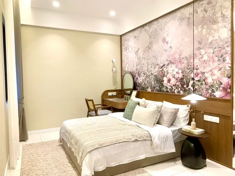 Bedroom features: king-size bed with white bedding, upholstered headboard, decorative pillows in various colors, nightstand with lamp, wooden chair, framed mirror, wall-mounted light fixture, floral wallpaper accent wall, cream painted walls, tile flooring, area rug with textured pattern, window with curtains; style: modern.