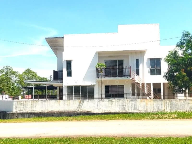 Exterior type: detached bungalow; features: white painted facade, flat roof, two-storey structure, balconies with railings, large windows with horizontal slats, manicured lawn in front, driveway leading to carport, surrounded by greenery, concrete base, staircase leading to upper level; style: modern.
