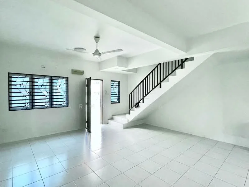 Room features: white painted walls, white tiled flooring, ceiling fan, staircase with black railing, window with metal grilles, door leading outside, natural light from windows; style: minimalist.